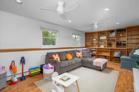 a living room with furniture kitchen view and a large window