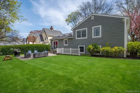 a front view of a house with a garden and plants