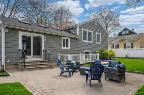a backyard of a house with yard fire pit and outdoor seating