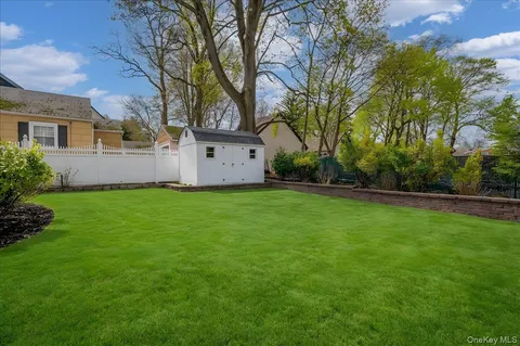a front view of house with yard and trees