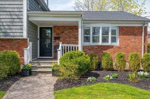 a front view of a house with garden