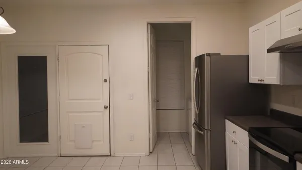 a kitchen with a refrigerator and cabinets