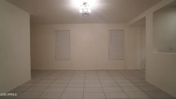 an empty room with white walls and tiles