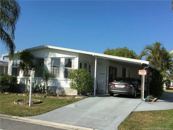 a view of house and car parked in front of house
