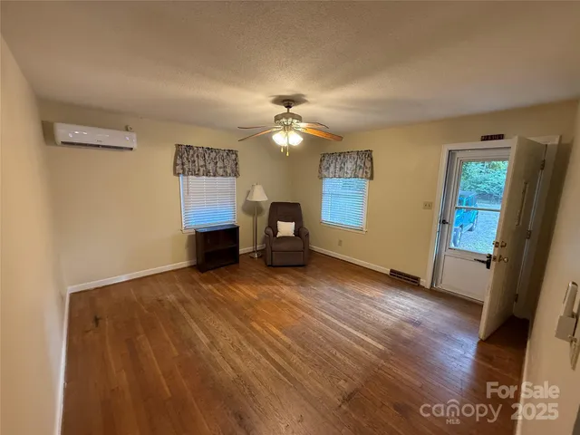 a view of a livingroom with furniture and wooden floor