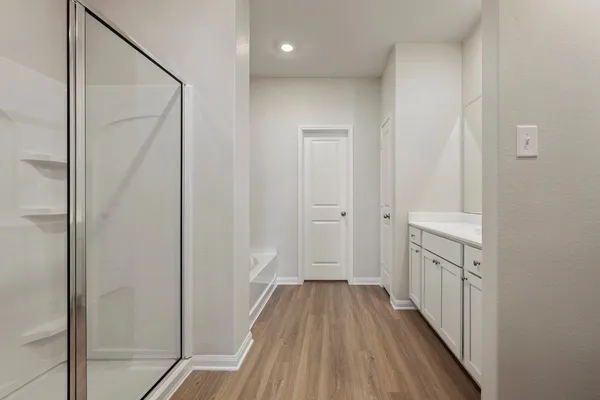 a view of a hallway with wooden floor