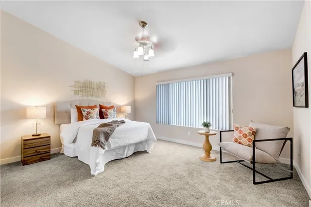 a bed room with a bed and a chair