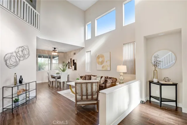 a living room with furniture a wooden floor a rug and a window