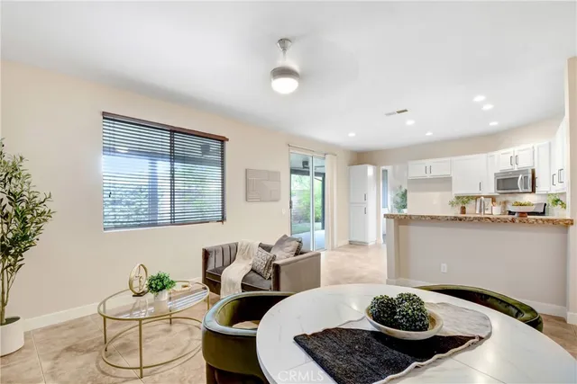 a living room with hard wood flooring and white furniture