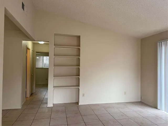 a view of an empty room and closet area