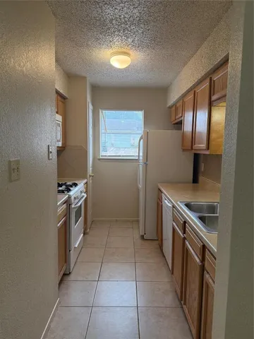 a kitchen with a stove top oven and cabinets