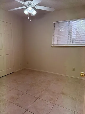a view of a livingroom with a chandelier fan
