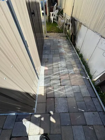 a living room with a bed next to a window with pc on the wall