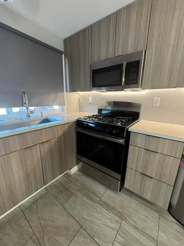 a room with wooden floor and mirror