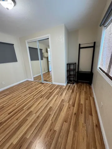 a bedroom with a bed and a mirror