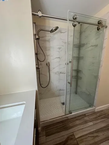 a bathroom with a shower a toilet and sink
