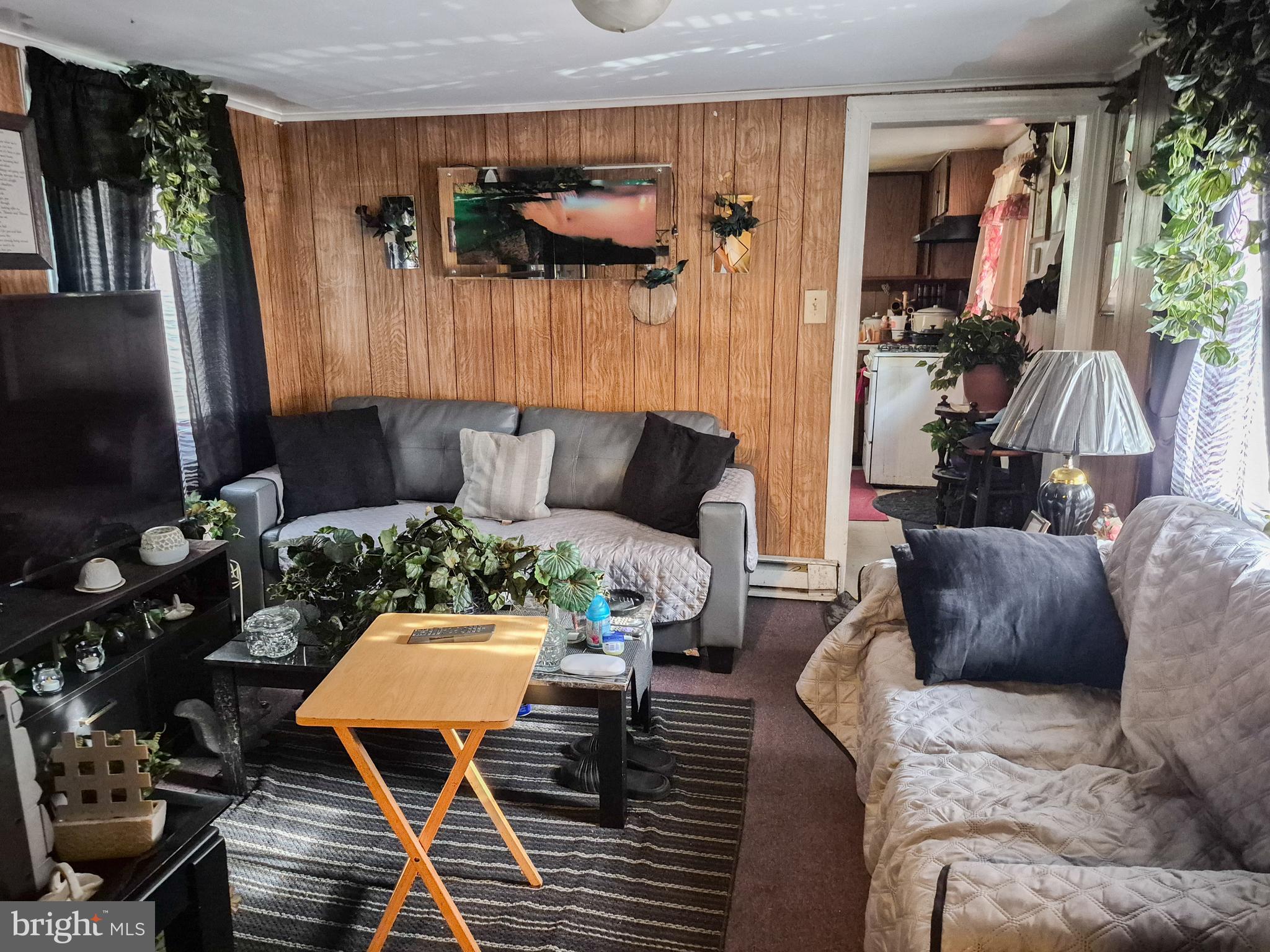 623 Cross Street Cambridge, MD 21613 - Photo 4 of 14 a living room with furniture and a flat screen tv