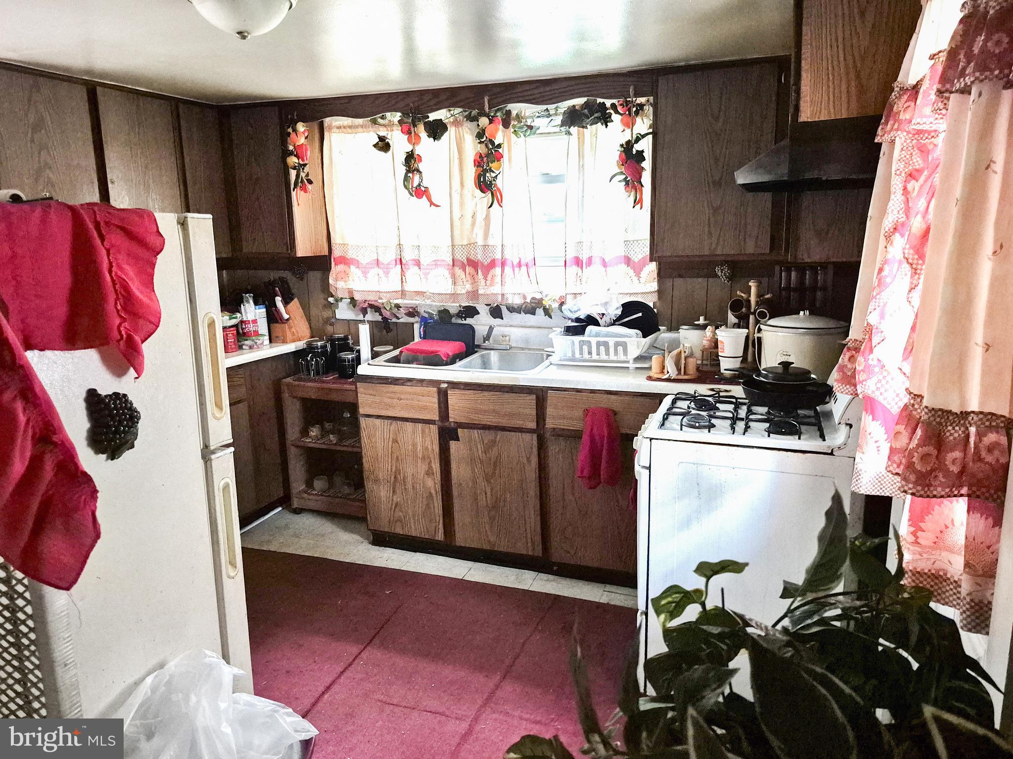 623 Cross Street Cambridge, MD 21613 - Photo 6 of 14 a kitchen with a sink cabinets and window