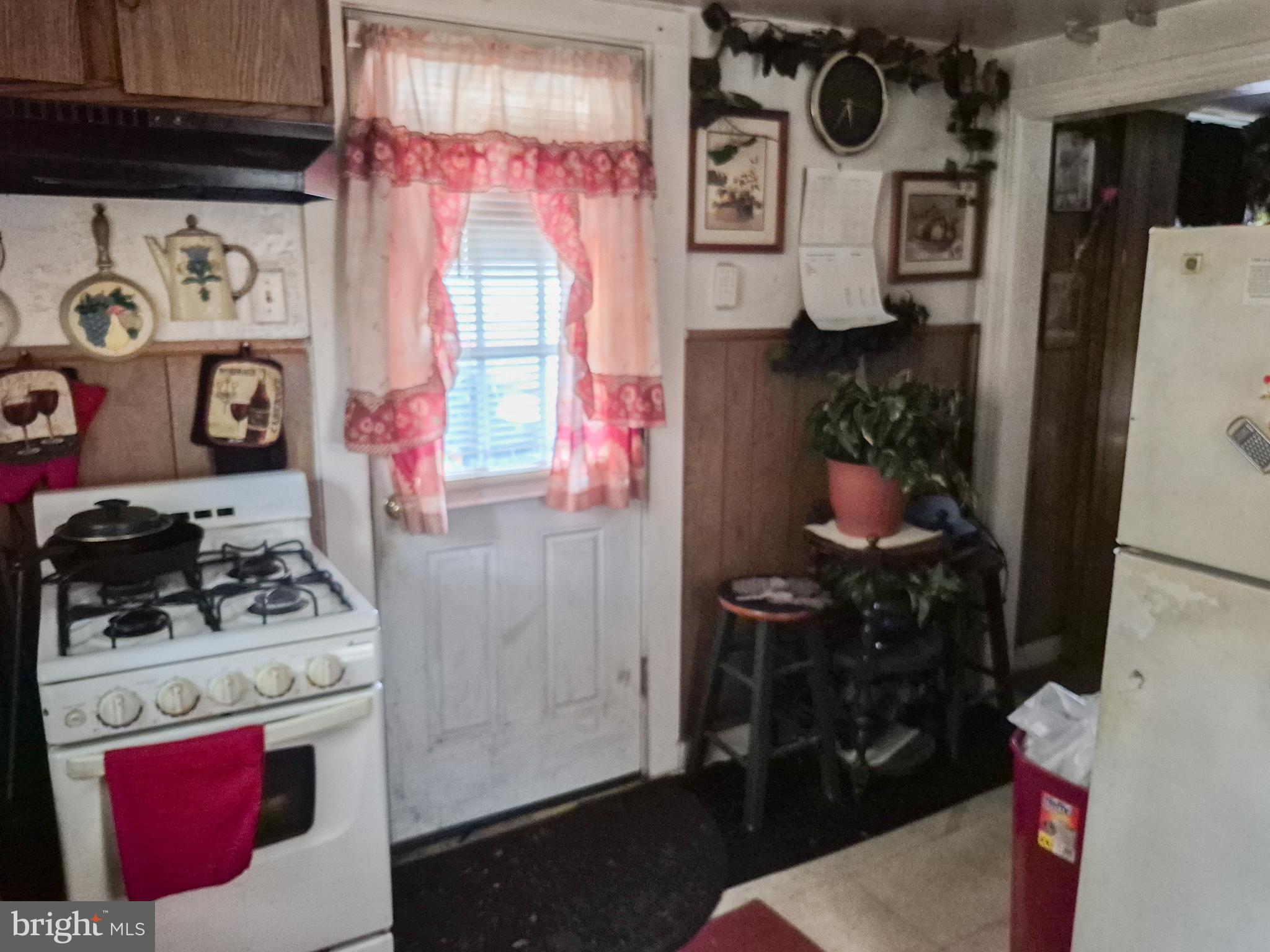 623 Cross Street Cambridge, MD 21613 - Photo 7 of 14 a kitchen with a stove and a refrigerator