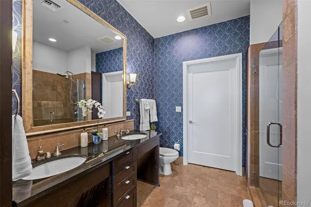 a bathroom with a double vanity sink and mirror