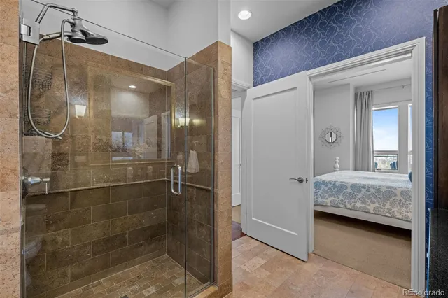 a bathroom with a glass shower door and a sink
