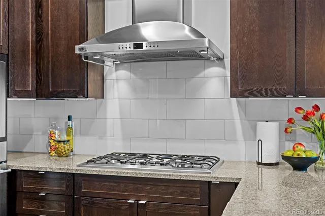 a stove top oven sitting inside of a kitchen
