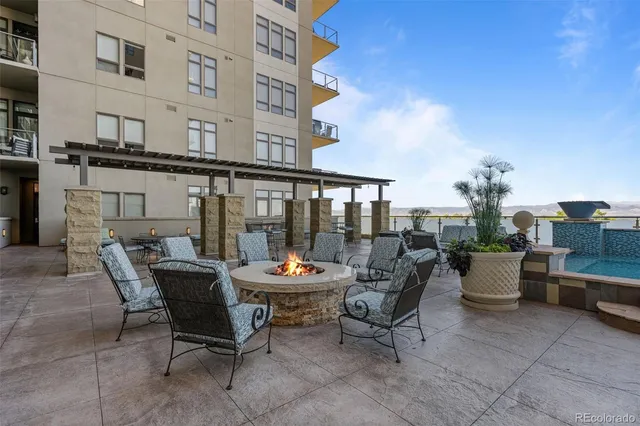 a balcony with furniture and potted plants