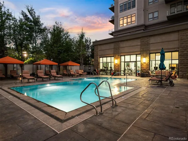 a swimming pool with outdoor seating yard and barbeque oven