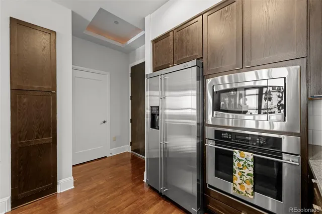 a kitchen with granite countertop stainless steel appliances and wooden cabinets