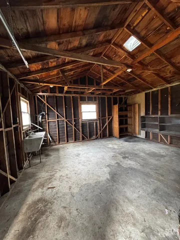 a view of empty room with wooden ceiling