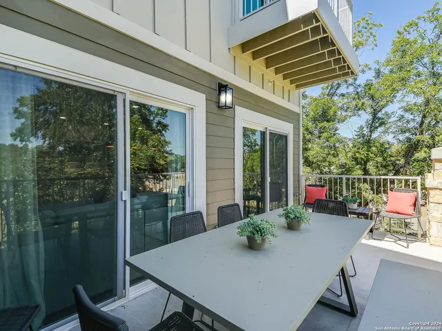 a view of a porch with furniture and floor to ceiling window