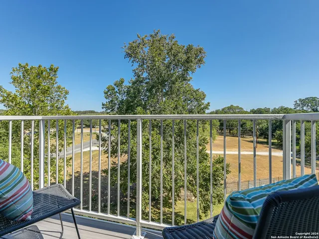 a view of a chair and table in the balcony