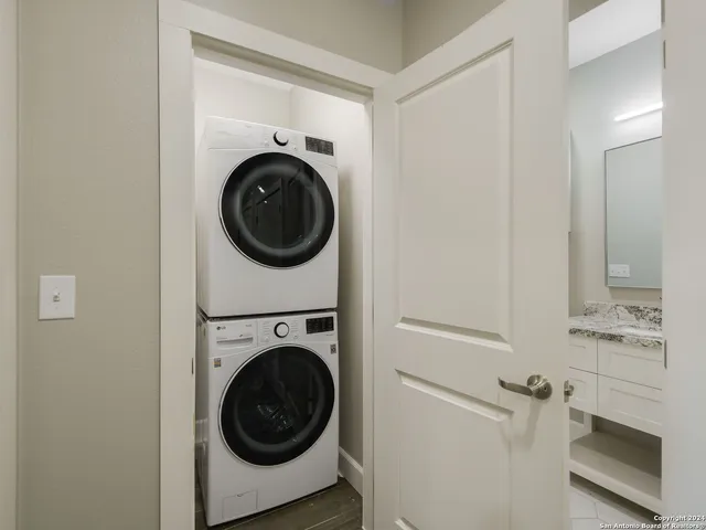 a utility room with sink dryer and washer
