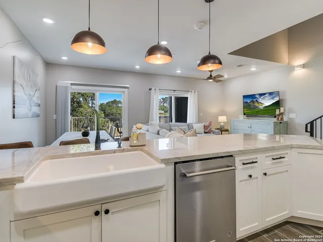 a kitchen with a sink and a chandelier