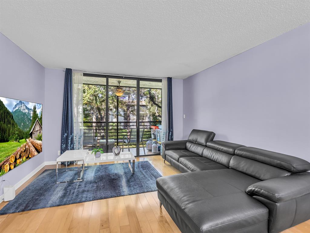 7579 Northwest 79th Avenue, Unit 204 Tamarac, FL 33321 - Photo 11 of 45 a living room with furniture and a flat screen tv