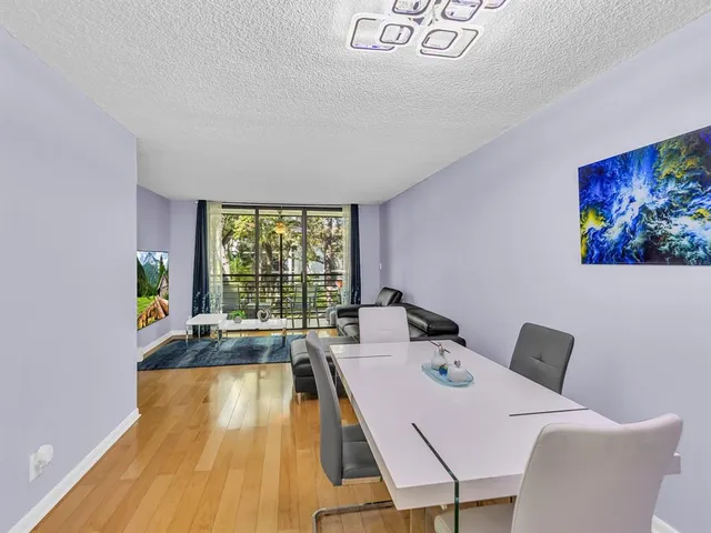 a view of a dining room with furniture wooden floor and a large window
