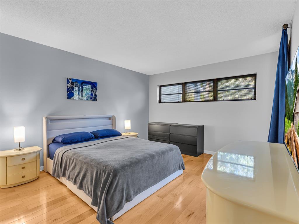 7579 Northwest 79th Avenue, Unit 204 Tamarac, FL 33321 - Photo 18 of 45 a bedroom with a bed and a couch