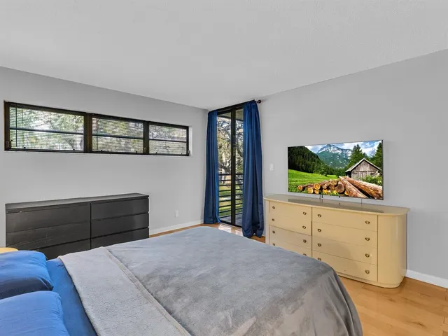 a bedroom with a bed and dresser