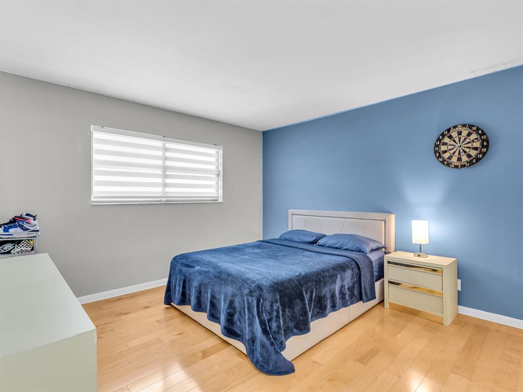 7579 Northwest 79th Avenue, Unit 204 Tamarac, FL 33321 - Photo 23 of 45 a bedroom with a bed and a window