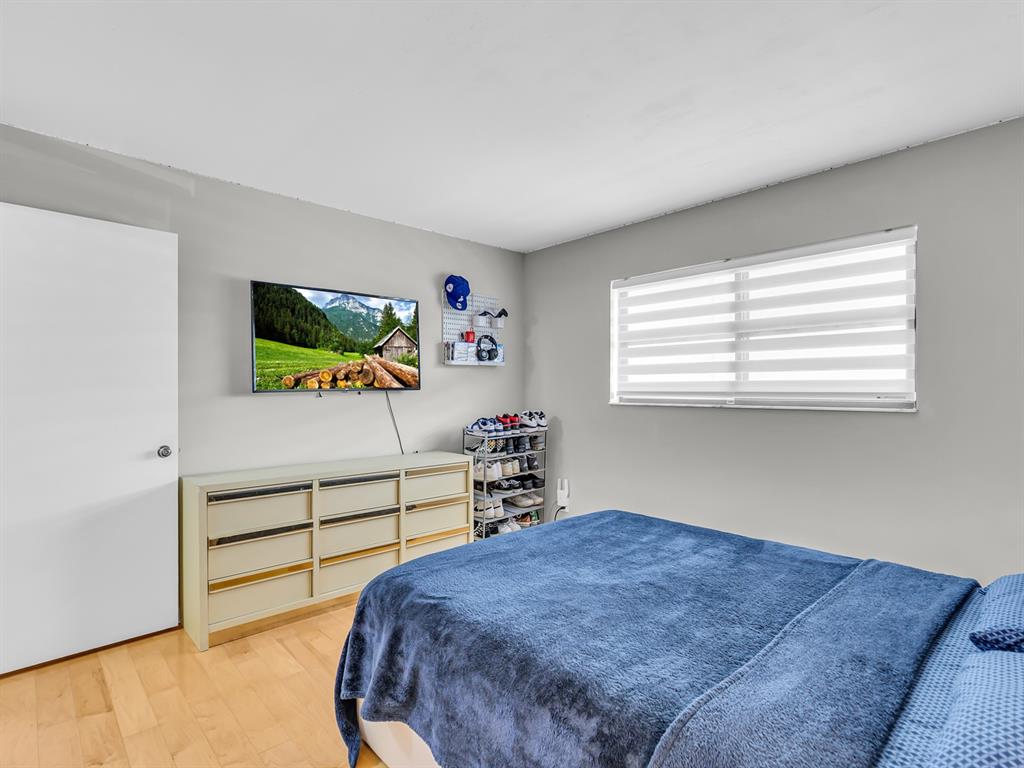 7579 Northwest 79th Avenue, Unit 204 Tamarac, FL 33321 - Photo 25 of 45 a bedroom with a bed and a dresser