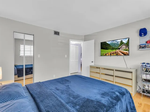 a bedroom with furniture and flat screen tv