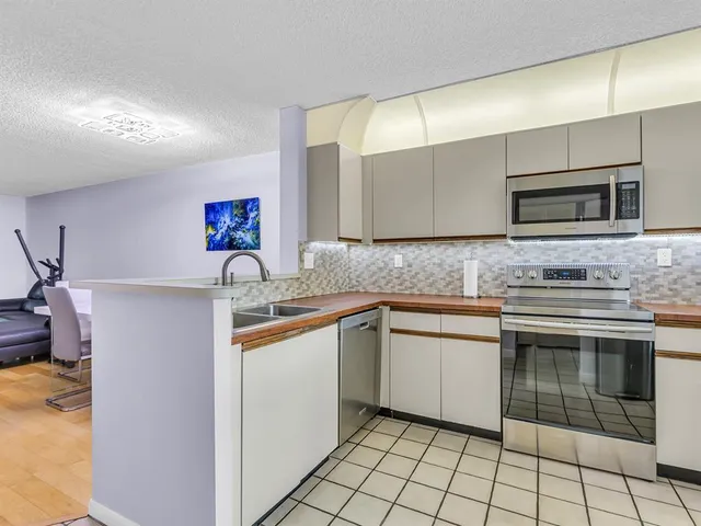 a kitchen with stainless steel appliances granite countertop a sink and a microwave