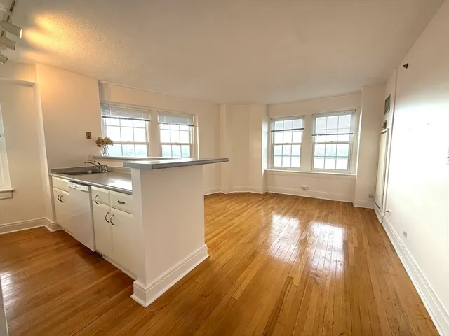 a kitchen with wooden floors and white appliances