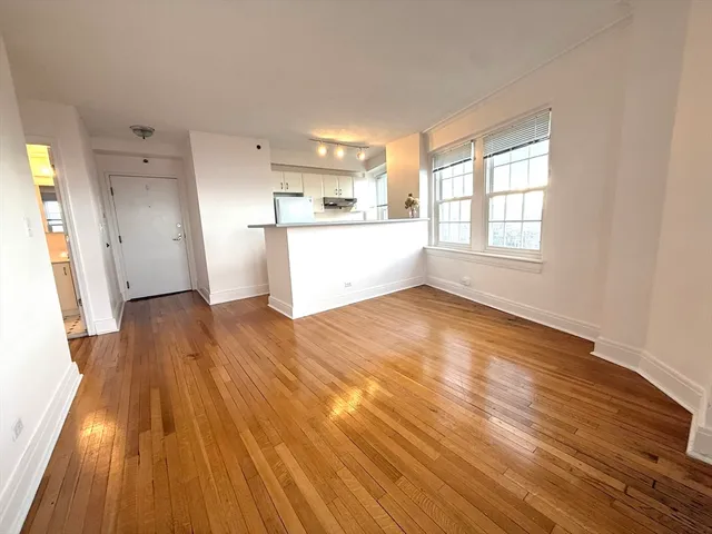a view of a kitchen with wooden floor and a sink