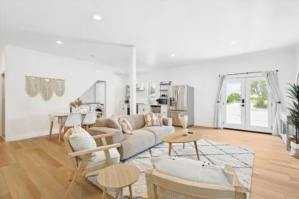 a living room with furniture and wooden floor