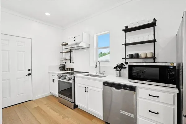 a kitchen with a stove and a microwave