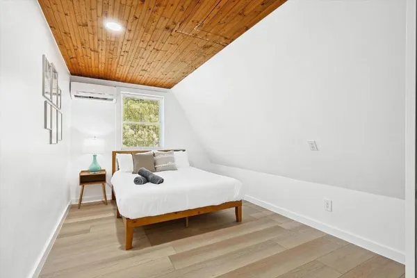 a bedroom with a bed and a window