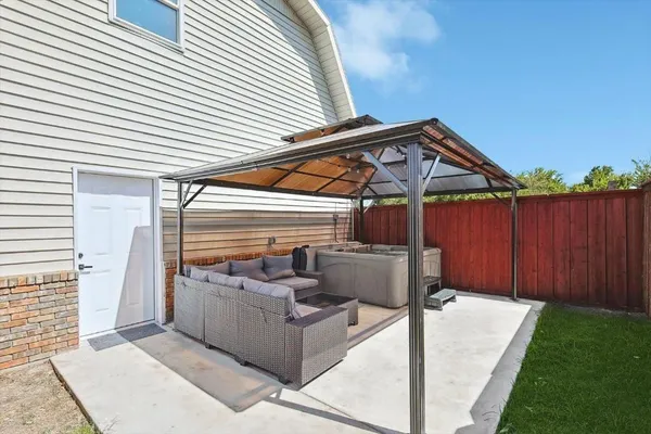 a patio with couches and potted plants