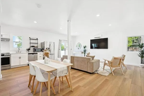 a view of a dining room with furniture wooden floor and windows