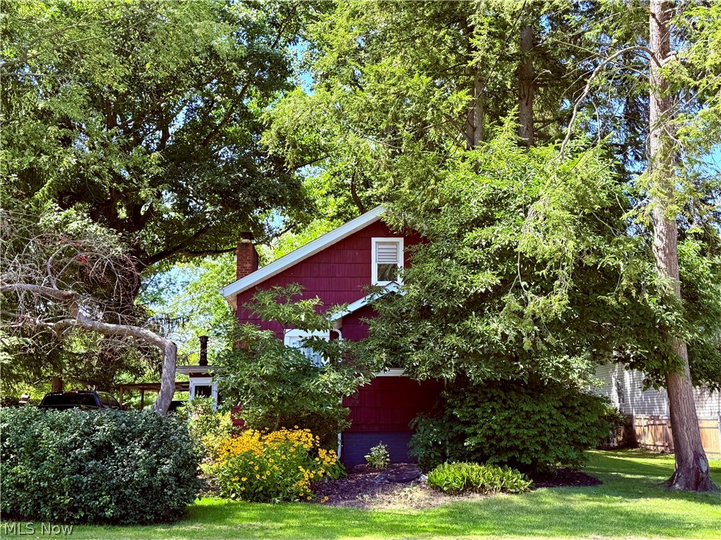 154 Taylor Road Barberton, OH 44203 - Photo 1 of 36 Front of red cedar shake home surrounded with trees and landscaping.